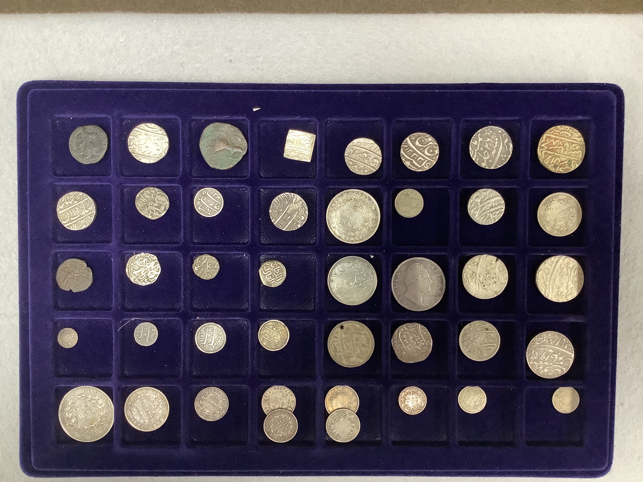 A collection of Indian coins mostly 16th-19th century, and UK silver crowns, half crowns and medals